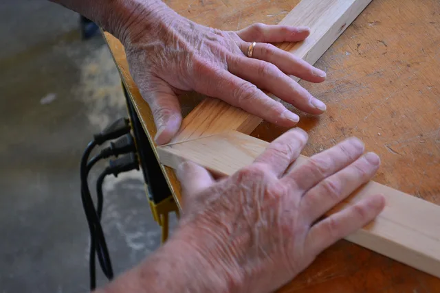 woodworker, hands, wooden frame, frame, picture frame, wood, woodwork, crafting, workshop, handicraft, closeup, woodworker, picture frame, woodwork, woodwork, woodwork, woodwork, woodwork, crafting. Glazing, matboard and hinges for memory display, compared for a first frame